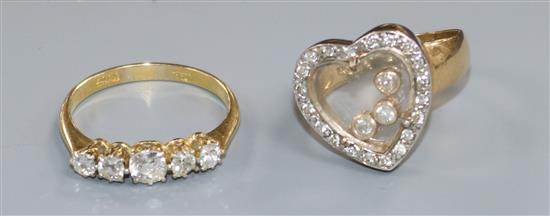 An 18ct gold and graduated five stone diamond ring and a 14ct gold and floating diamond heart shaped ring.